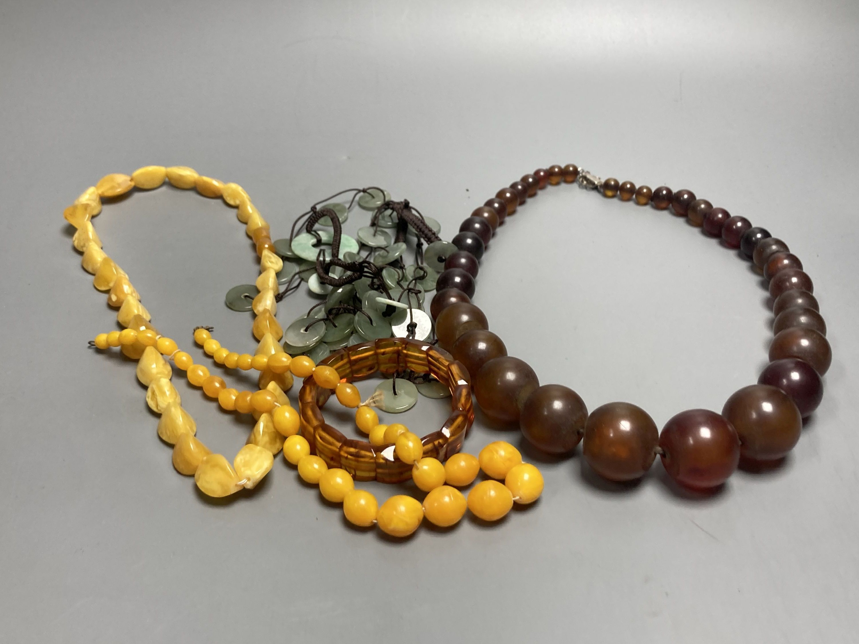 A pale yellow amber bead necklace, 56cm, gross 45 grams and other necklaces including simulated amber.